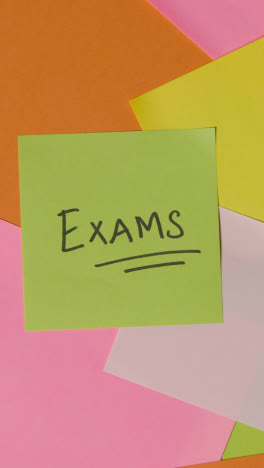 Vertical-Video-Education-Concept-Of-Revolving-Sticky-Notes-With-Exams-Written-On-Top-Note